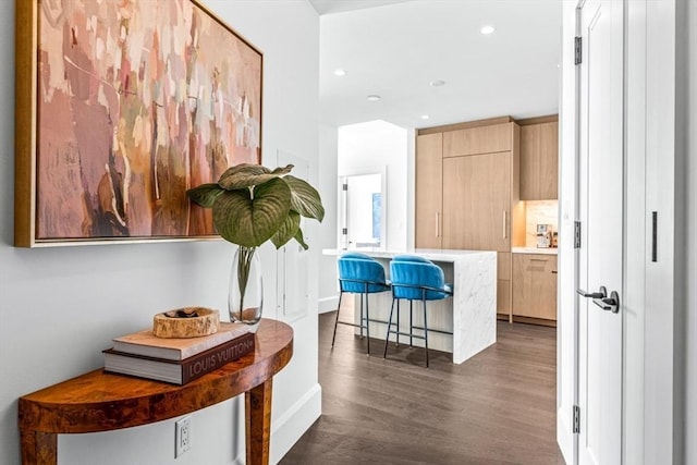 hall with baseboards, dark wood-style flooring, and recessed lighting