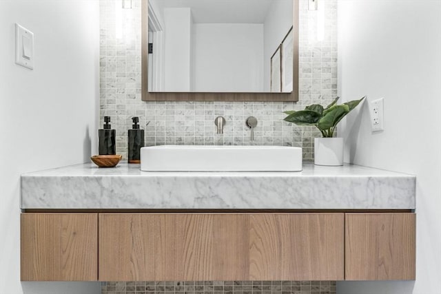 bathroom with tasteful backsplash and a sink