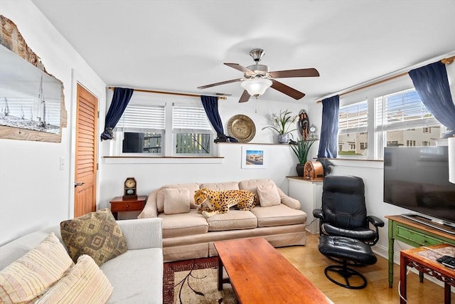 living room with ceiling fan and light hardwood / wood-style flooring