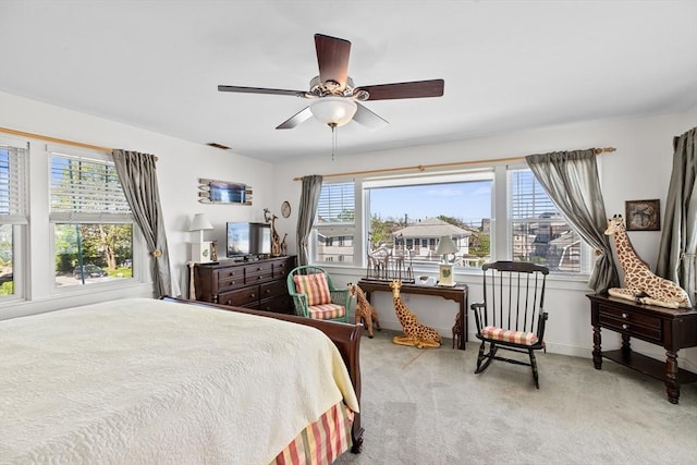 bedroom featuring ceiling fan and light carpet