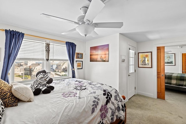 bedroom featuring ceiling fan and carpet