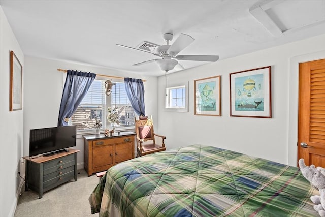 bedroom with ceiling fan and light carpet