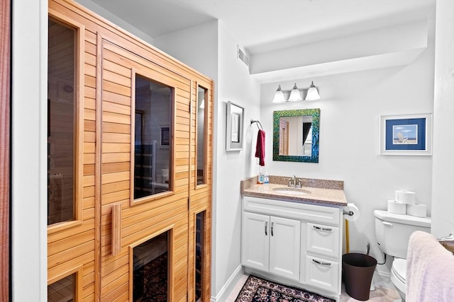 bathroom featuring toilet and vanity