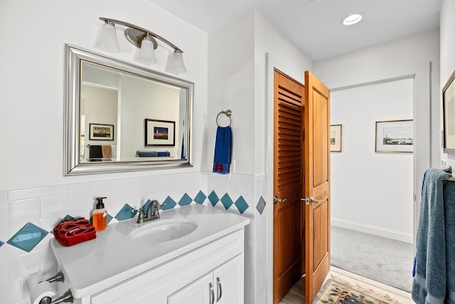 bathroom featuring vanity and backsplash