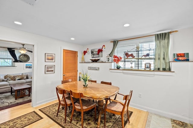 dining room with ceiling fan and light hardwood / wood-style flooring