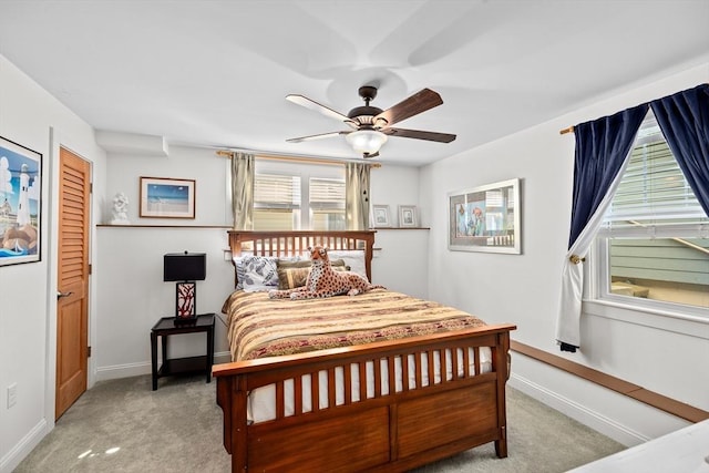 bedroom with ceiling fan, carpet floors, and multiple windows