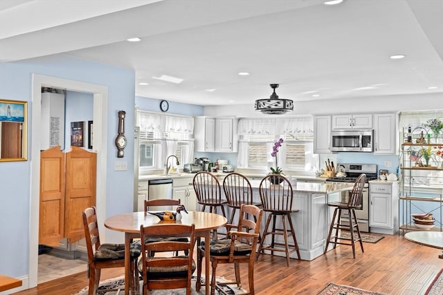 dining room with light wood-type flooring and sink