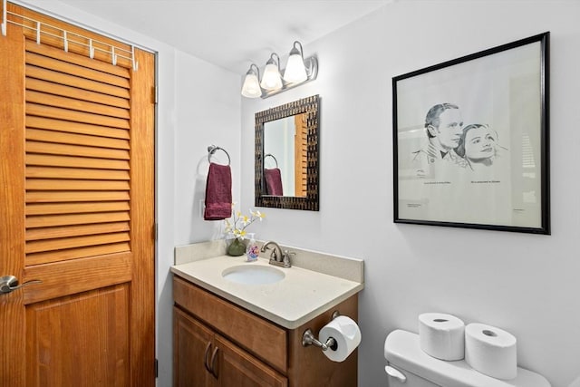 bathroom featuring toilet and vanity