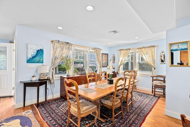 dining space featuring light wood-type flooring and a wealth of natural light