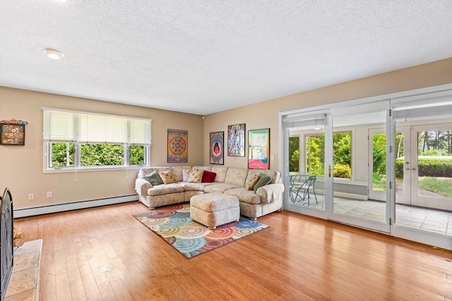 76 Beaver Rd, Ware, MA 01082 - living area with a baseboard heating unit, a textured ceiling, french doors, and hardwood / wood-style floors