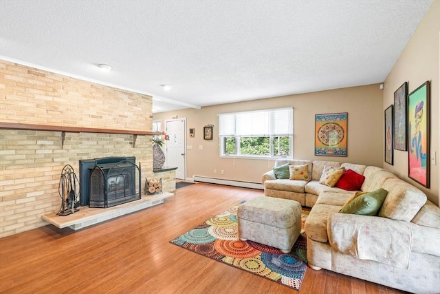 76 Beaver Rd, Ware, MA 01082 - living area featuring baseboard heating, a textured ceiling, and wood finished floors