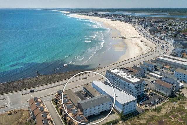 birds eye view of property featuring a water view and a view of the beach