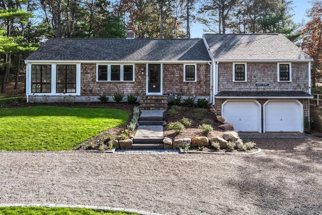 single story home with a front yard and a garage