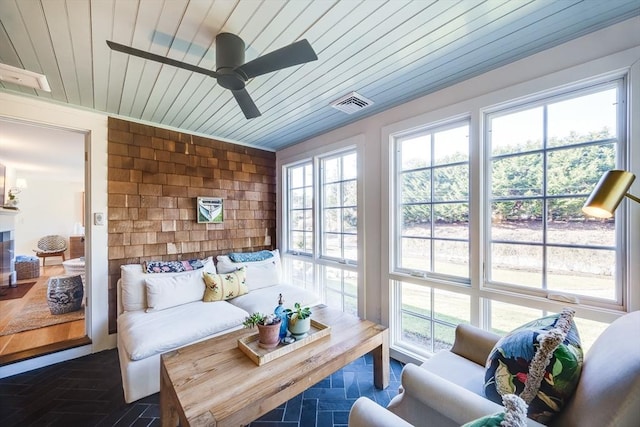 sunroom / solarium with wooden ceiling and ceiling fan