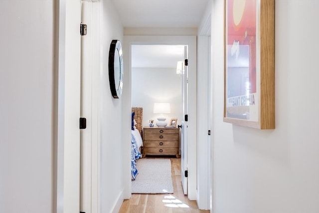 hallway with light hardwood / wood-style flooring