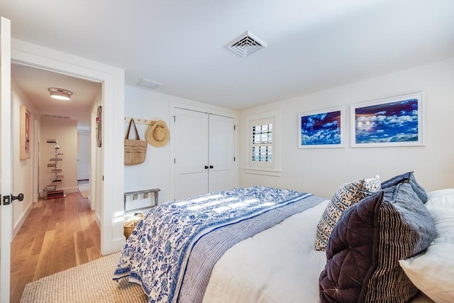 bedroom with a closet and light hardwood / wood-style floors