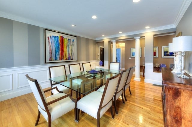 dining area with recessed lighting, light wood finished floors, decorative columns, and wainscoting