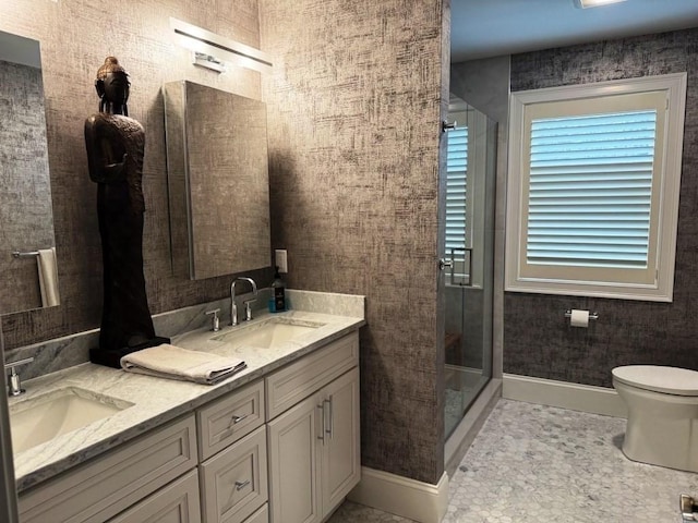 full bathroom featuring a stall shower, a sink, and toilet