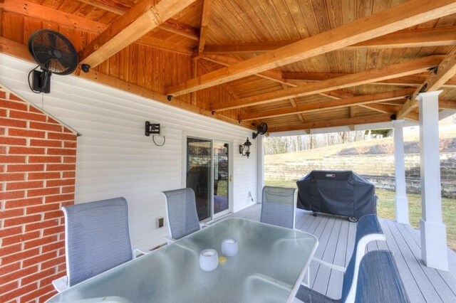 wooden deck featuring outdoor dining area and a grill