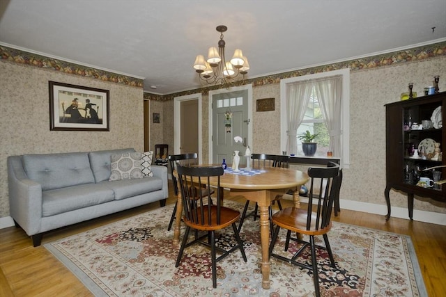 299 Shaker Rd, Westfield, MA 01085 - dining area with wallpapered walls, a chandelier, wood finished floors, ornamental molding, and baseboards