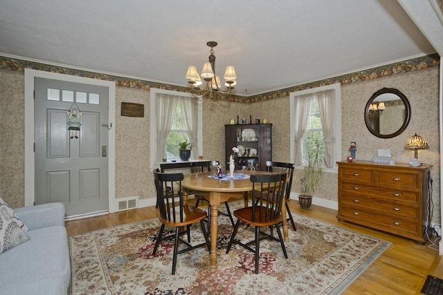 299 Shaker Rd, Westfield, MA 01085 - dining space with wallpapered walls, a chandelier, plenty of natural light, wood finished floors, and ornamental molding