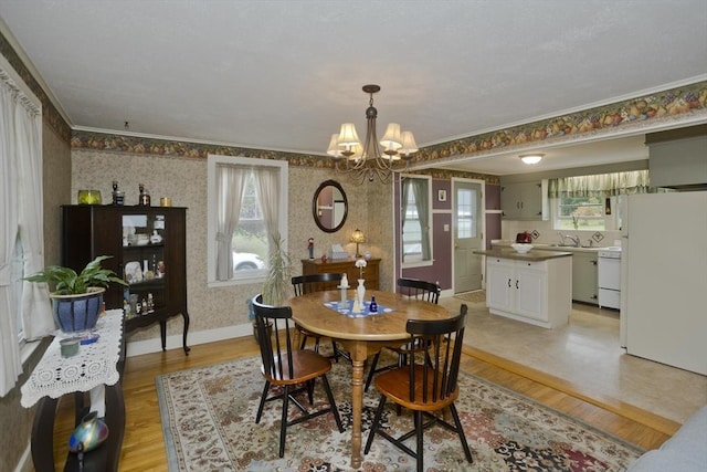 299 Shaker Rd, Westfield, MA 01085 - dining area featuring wallpapered walls, light wood finished floors, a chandelier, ornamental molding, and baseboards