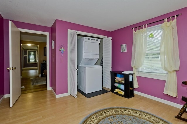 299 Shaker Rd, Westfield, MA 01085 - washroom with estacked washer and dryer, light wood-style flooring, and baseboards