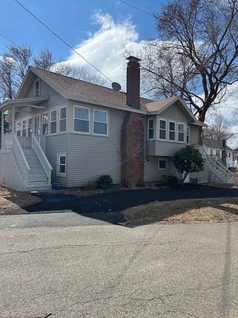 exterior space with a chimney and stairs