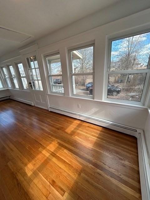 unfurnished sunroom with a baseboard heating unit