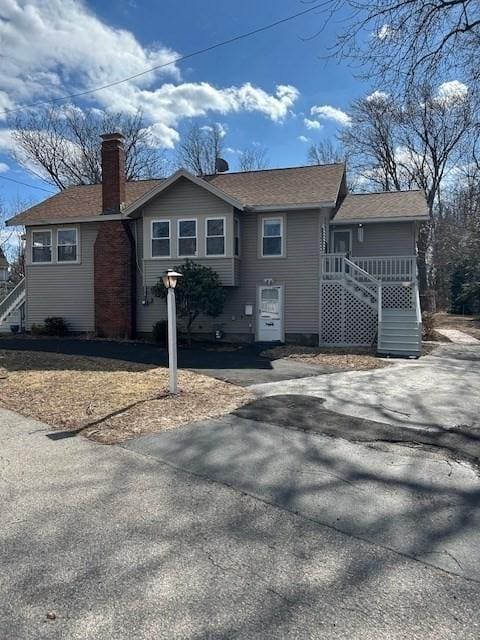 single story home featuring a chimney