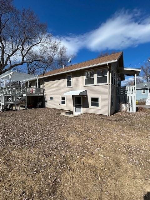 rear view of house with a wooden deck and stairs