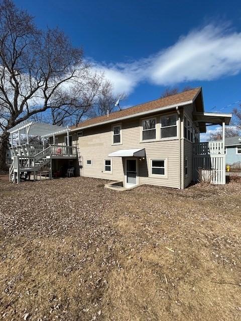 back of property with stairway and a deck