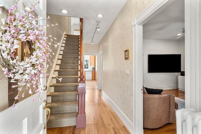 25 Autumn St, Everett, MA 02149 - foyer entrance with radiator, wallpapered walls, light wood-style flooring, stairway, and a ceiling fan