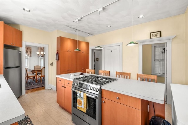25 Autumn St, Everett, MA 02149 - kitchen featuring stainless steel appliances, a breakfast bar, light countertops, light flooring, and recessed lighting