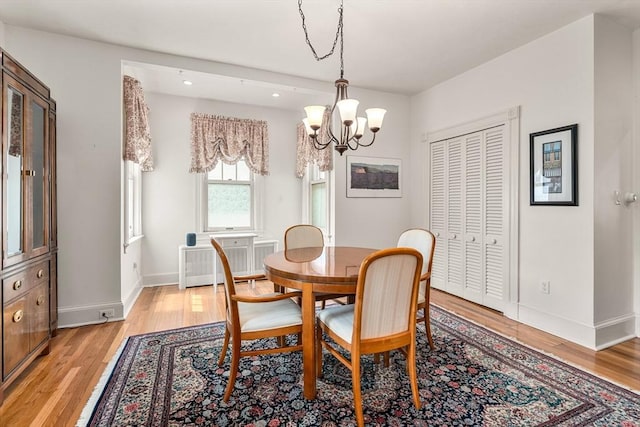 25 Autumn St, Everett, MA 02149 - dining space with radiator, a chandelier, and light wood-type flooring