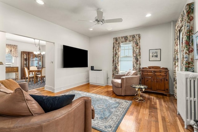 25 Autumn St, Everett, MA 02149 - living room with radiator heating unit, a ceiling fan, a chandelier, hardwood / wood-style flooring, and recessed lighting