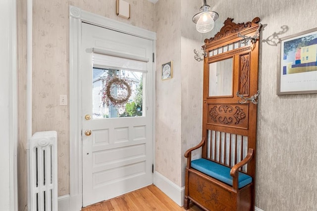 25 Autumn St, Everett, MA 02149 - foyer featuring wallpapered walls, wood finished floors, and radiator heating unit