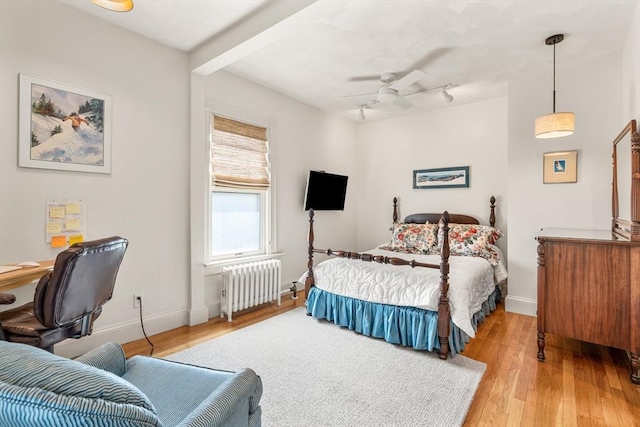 25 Autumn St, Everett, MA 02149 - bedroom with radiator heating unit, light wood-type flooring, ceiling fan, and an office area