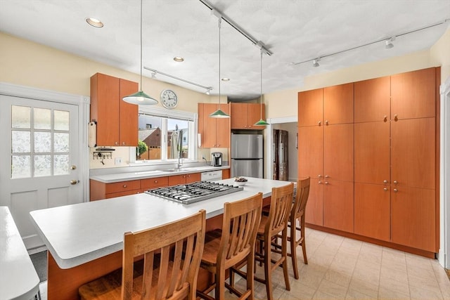 25 Autumn St, Everett, MA 02149 - kitchen with appliances with stainless steel finishes, a breakfast bar, light countertops, pendant lighting, and a center island