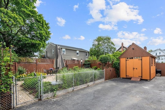 25 Autumn St, Everett, MA 02149 - view of front facade featuring a storage unit, a fenced backyard, and a gate