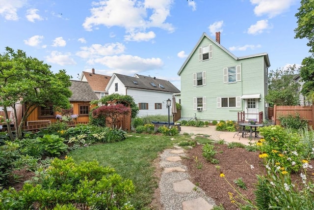 25 Autumn St, Everett, MA 02149 - back of property featuring a patio and a chimney