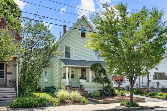 25 Autumn St, Everett, MA 02149 - american foursquare style home featuring covered porch, a chimney, and a shingled roof