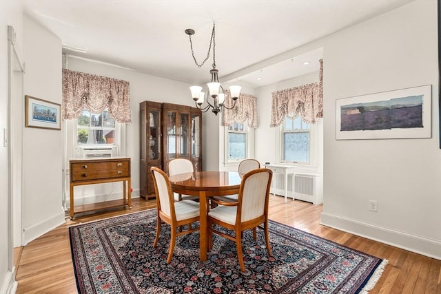 25 Autumn St, Everett, MA 02149 - dining space featuring a chandelier, light wood-type flooring, and radiator heating unit