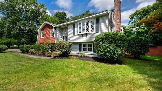 rear view of property featuring a lawn