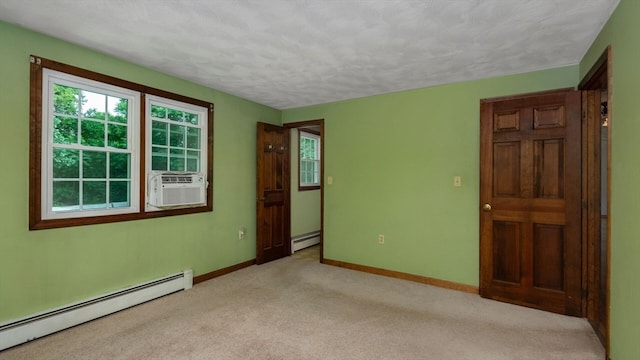 carpeted spare room with cooling unit, a textured ceiling, and a baseboard radiator