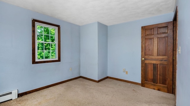 carpeted empty room featuring a baseboard radiator