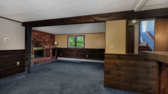 carpeted living room with a brick fireplace, beamed ceiling, wood walls, and baseboard heating