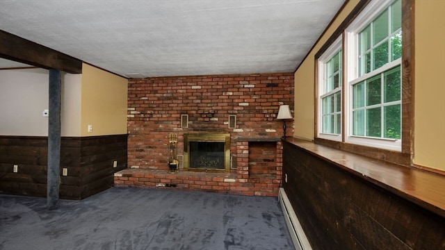 unfurnished living room featuring a fireplace, dark carpet, and a textured ceiling