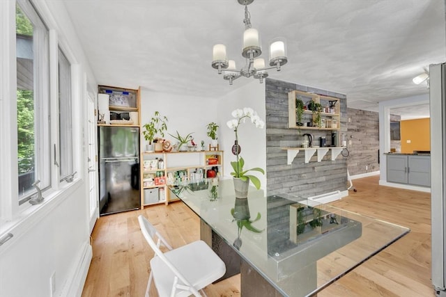 825 S St, Tewksbury, MA 01876 - dining area with a chandelier, light wood finished floors, baseboards, and wooden walls