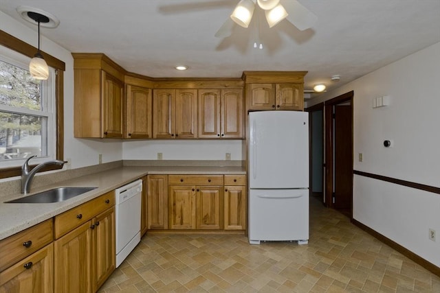 kitchen with ceiling fan, sink, white appliances, and decorative light fixtures